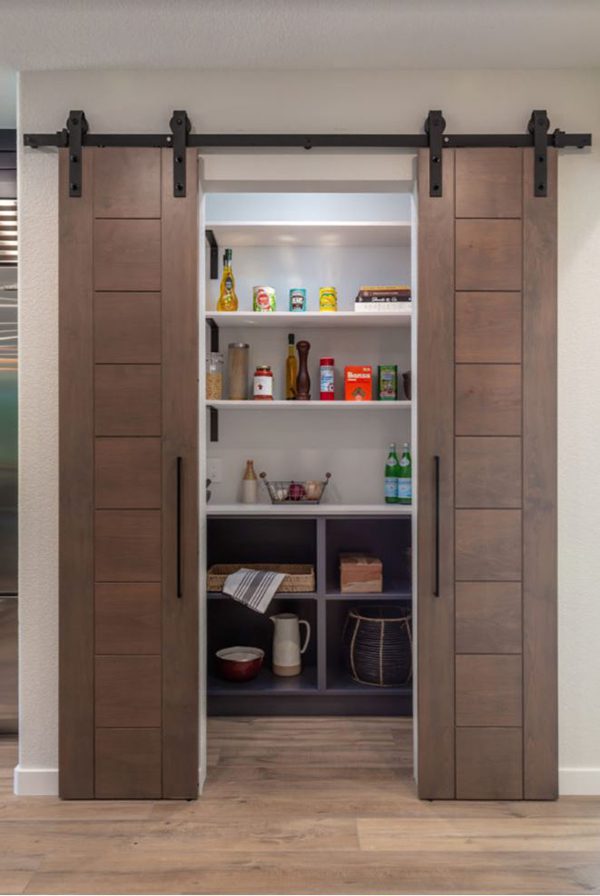 a design build remodeler can help you think of creative storage solutions like this pantry with sliding barn doors