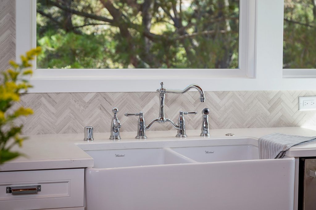 kitchen remodel with matching countertops and backsplash, farmhouse sink